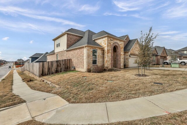 252 Sabino Dr, Buda, TX 78610 - view of front of house featuring stone siding and a garage