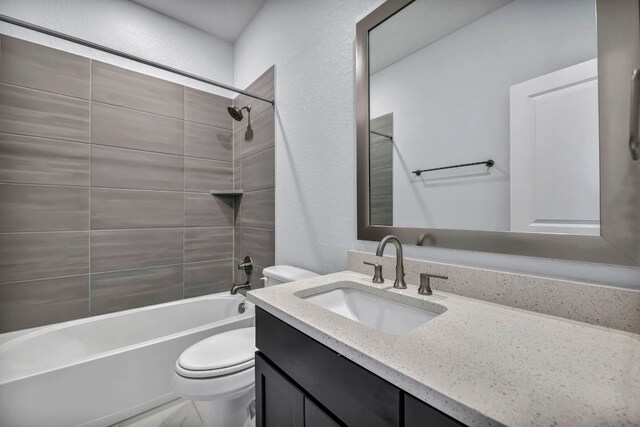 252 Sabino Dr, Buda, TX 78610 - bathroom with toilet, vanity, washtub / shower combination, and a textured wall