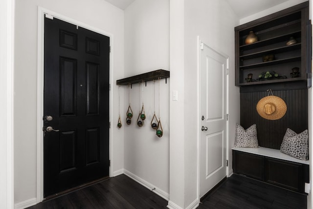 mudroom featuring dark wood-style floors and baseboards