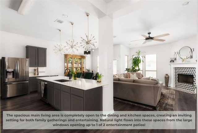 kitchen with visible vents, light countertops, appliances with stainless steel finishes, dark wood-style floors, and a sink