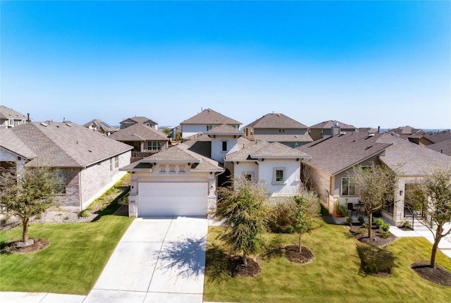 view of front of property featuring a residential view, a garage, driveway, and a front yard