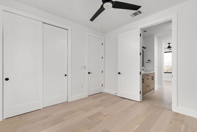 802 Philco Dr Unit 1, Austin, TX 78745 - unfurnished bedroom with light wood-style floors, ceiling fan, and a closet
