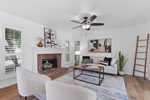 8423 Racine Trl, Austin, TX 78717 - living area with wood finished floors, a ceiling fan, a fireplace, and baseboards