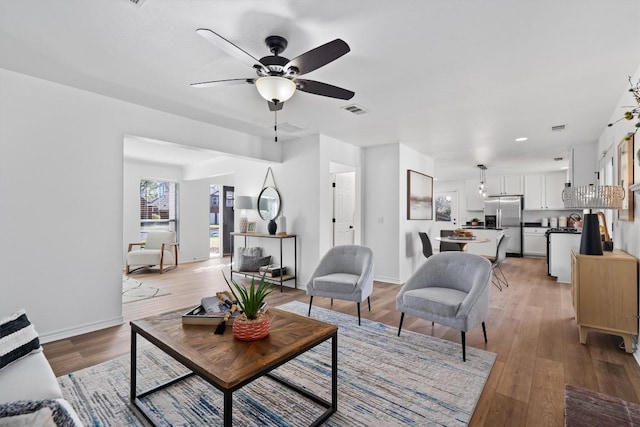 8423 Racine Trl, Austin, TX 78717 - living room with ceiling fan, light wood finished floors, and baseboards