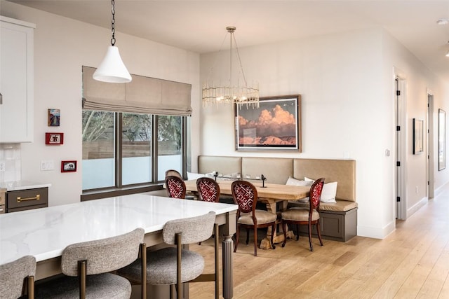 4408 Jinx Ave Unit 1, Austin, TX 78745 - dining area featuring breakfast area, light wood-type flooring, and a chandelier
