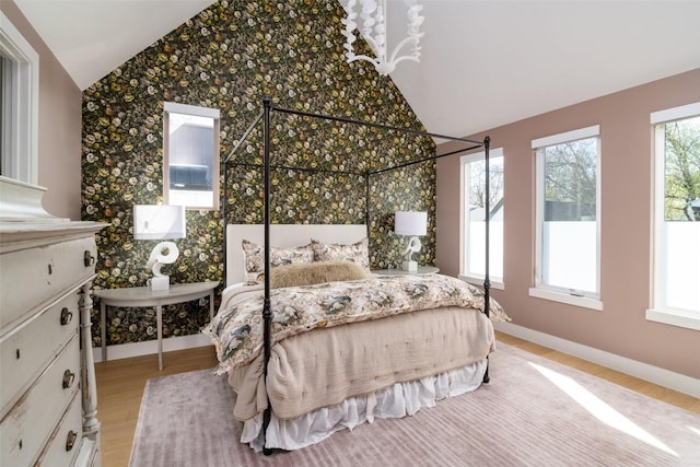 4408 Jinx Ave Unit 1, Austin, TX 78745 - bedroom with vaulted ceiling, light wood-style floors, and wallpapered walls
