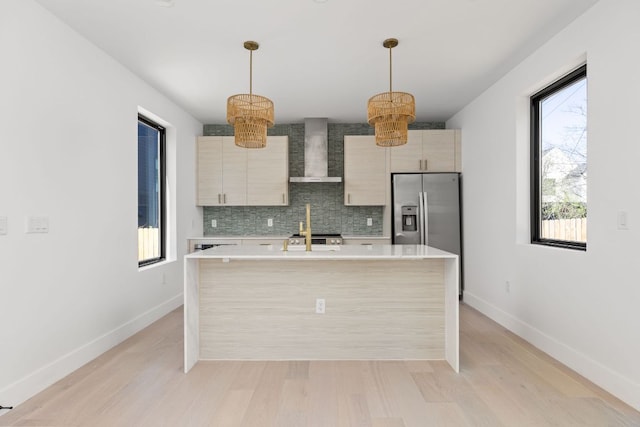 802 Philco Dr Unit 2, Austin, TX 78745 - kitchen with wall chimney exhaust hood, stainless steel fridge with ice dispenser, light countertops, tasteful backsplash, and baseboards