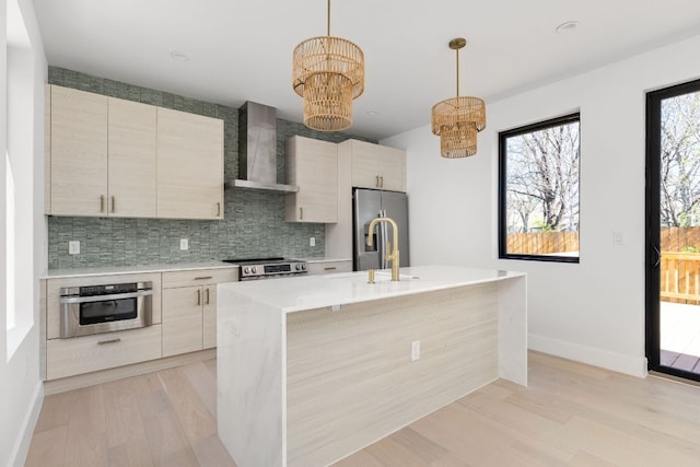 802 Philco Dr Unit 2, Austin, TX 78745 - kitchen featuring wall chimney exhaust hood, appliances with stainless steel finishes, a chandelier, light countertops, and tasteful backsplash