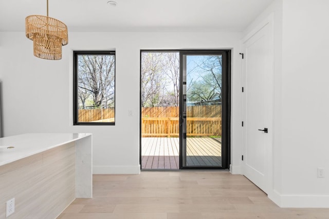 802 Philco Dr Unit 2, Austin, TX 78745 - entryway with light wood finished floors, baseboards, a chandelier, and plenty of natural light