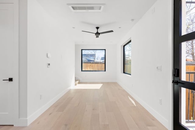 802 Philco Dr Unit 2, Austin, TX 78745 - empty room with light wood-style floors, a ceiling fan, and baseboards