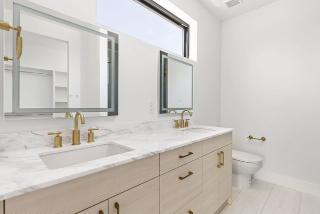 802 Philco Dr Unit 2, Austin, TX 78745 - bathroom featuring toilet, double vanity, and baseboards