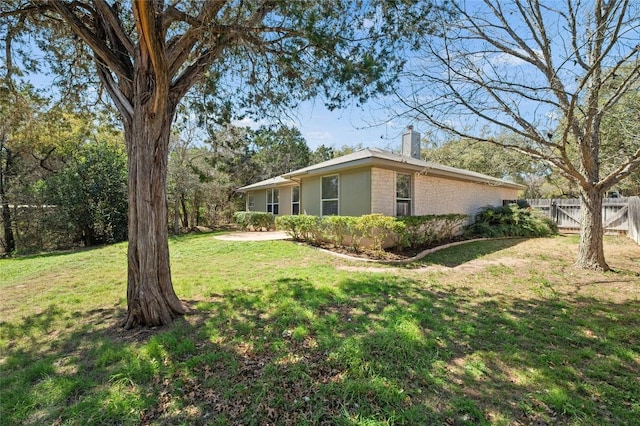 5709 Hudson Bend Rd, Austin, TX 78734 - view of side of property with a chimney and brick siding