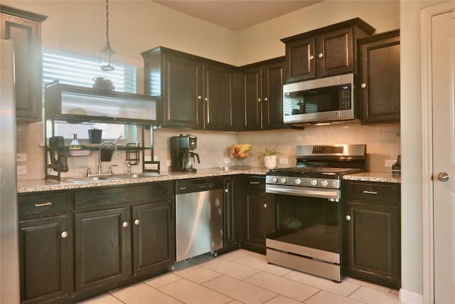 1400 Bess Cv, Leander, TX 78641 - kitchen featuring stainless steel appliances, a sink, backsplash, and light tile patterned floors