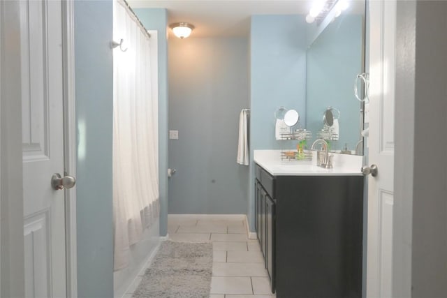 1400 Bess Cv, Leander, TX 78641 - bathroom with tile patterned floors, vanity, baseboards, and shower / tub combo