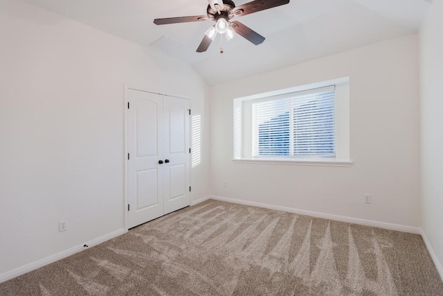 422 Village Commons Blvd, Georgetown, TX 78633 - unfurnished bedroom with carpet, baseboards, vaulted ceiling, a closet, and a ceiling fan