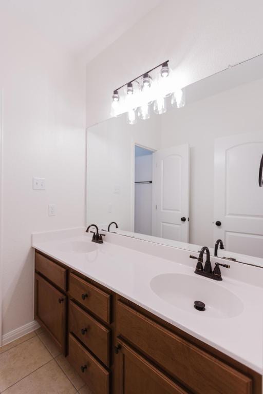 422 Village Commons Blvd, Georgetown, TX 78633 - bathroom featuring double vanity, tile patterned floors, and baseboards