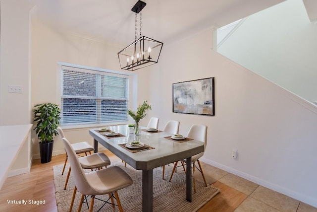 422 Village Commons Blvd, Georgetown, TX 78633 - dining area featuring a chandelier, baseboards, and light wood-type flooring