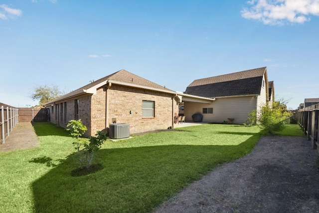 2502 Grey Kirby Dr, League City, TX 77573 - back of property with brick siding, central air condition unit, and a shingled roof