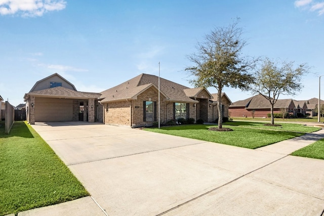 2502 Grey Kirby Dr, League City, TX 77573 - view of front of house featuring brick siding, concrete driveway, a front lawn, roof with shingles, and a garage