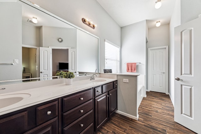 2502 Grey Kirby Dr, League City, TX 77573 - full bath featuring double vanity, a bath, wood finished floors, and baseboards