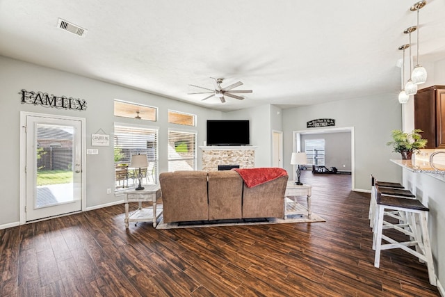 2502 Grey Kirby Dr, League City, TX 77573 - living area with ceiling fan, a fireplace, dark wood-style floors, and baseboards