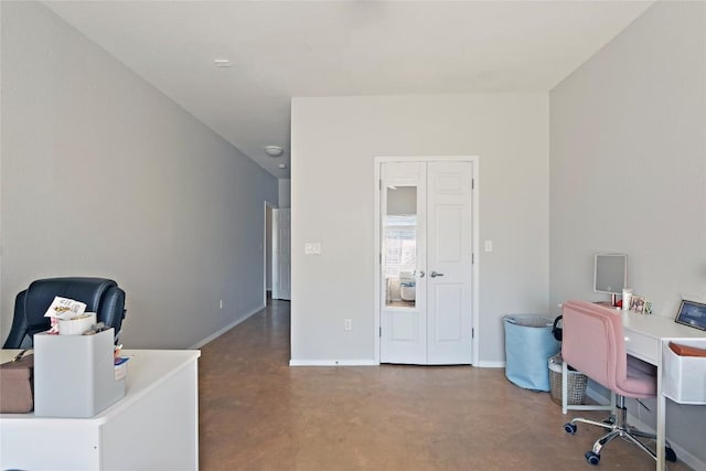 office with baseboards and finished concrete flooring