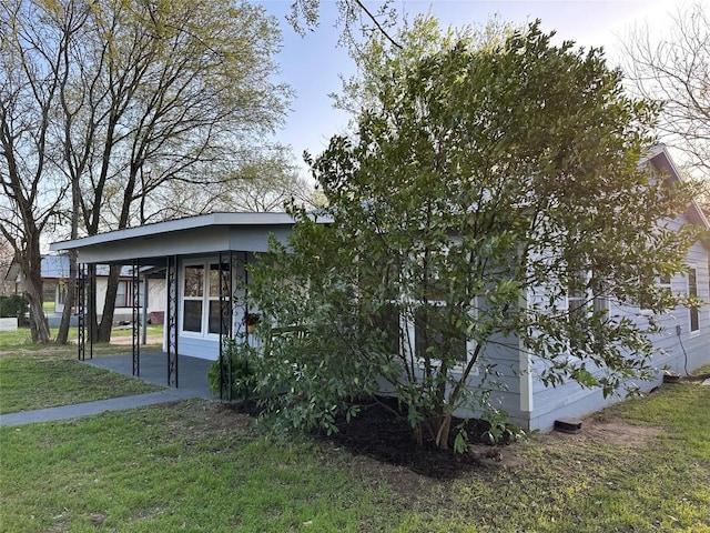 view of front of home with a front yard and a carport