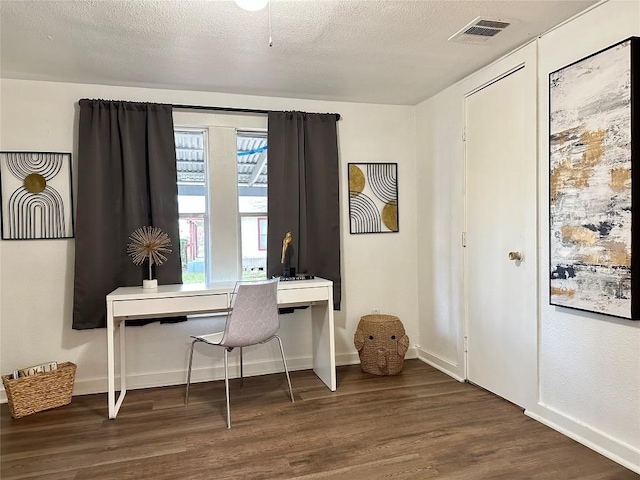 office space with visible vents, wood finished floors, and baseboards
