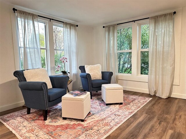 living area featuring wood finished floors and baseboards