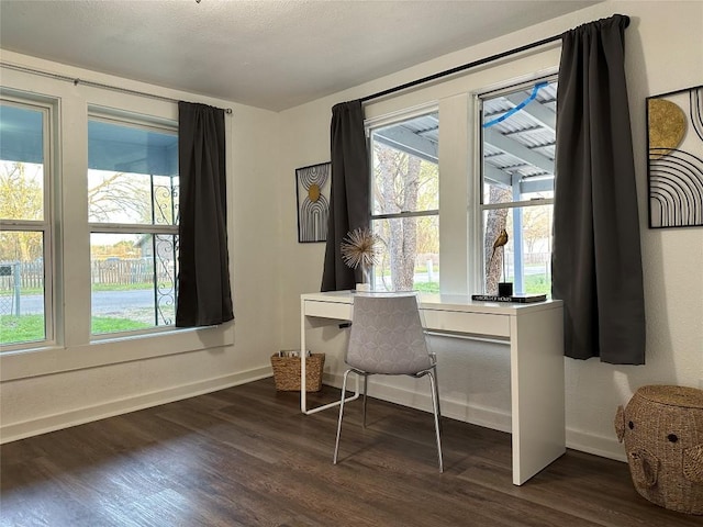 home office with dark wood-style floors and baseboards
