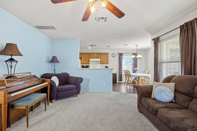 1631 Plume Grass Pl, Round Rock, TX 78665 - carpeted living area featuring a chandelier and ceiling fan