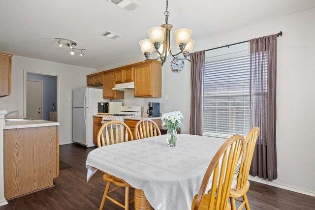 1631 Plume Grass Pl, Round Rock, TX 78665 - dining room with a chandelier, dark wood-style flooring, and baseboards