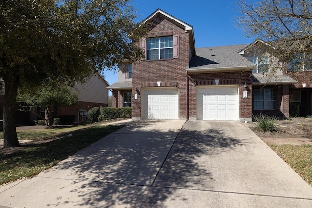 101 Verde Ranch Loop, Leander, TX 78641 - view of front of home with brick siding, driveway, roof with shingles, and a garage