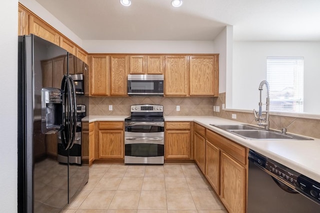 101 Verde Ranch Loop, Leander, TX 78641 - kitchen with black appliances, a sink, backsplash, light countertops, and light tile patterned floors