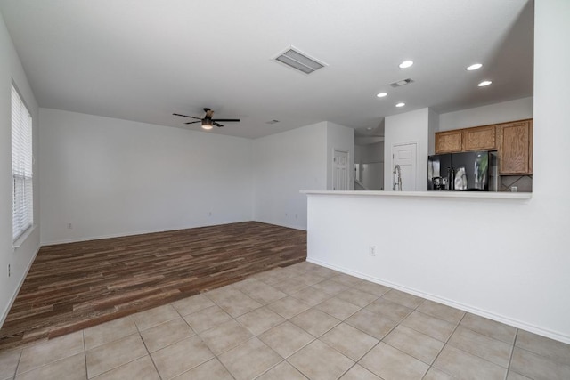 101 Verde Ranch Loop, Leander, TX 78641 - unfurnished living room with light wood-style floors, ceiling fan, recessed lighting, a sink, and baseboards