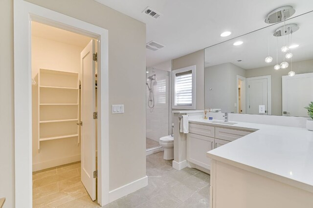8702 Silverhill Ln, Austin, TX 78759 - full bathroom featuring a stall shower, vanity, toilet, recessed lighting, and a walk in closet