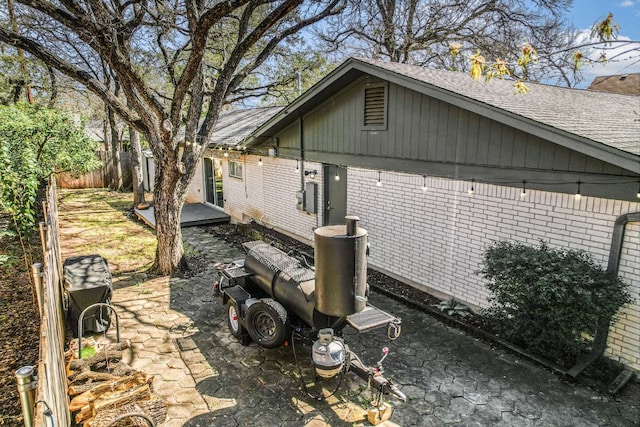 8702 Silverhill Ln, Austin, TX 78759 - view of side of home with brick siding and a shingled roof