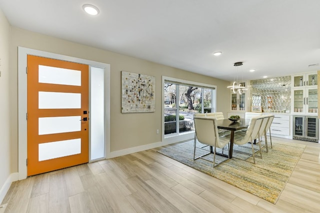 8702 Silverhill Ln, Austin, TX 78759 - dining space with beverage cooler, light wood-style floors, a chandelier, baseboards, and recessed lighting