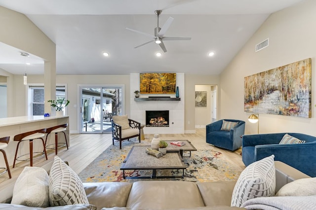 8702 Silverhill Ln, Austin, TX 78759 - living room featuring wood finished floors, a ceiling fan, recessed lighting, a fireplace, and high vaulted ceiling