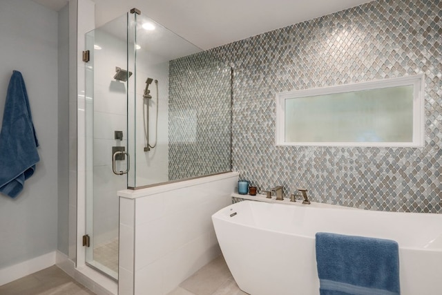 8702 Silverhill Ln, Austin, TX 78759 - full bathroom with a stall shower, a soaking tub, tile walls, and tile patterned floors