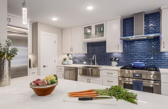 8702 Silverhill Ln, Austin, TX 78759 - kitchen with stainless steel appliances, wall chimney exhaust hood, a sink, light countertops, and backsplash