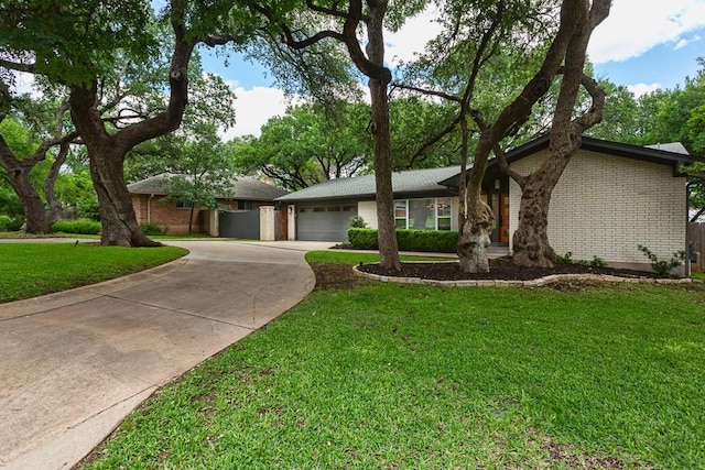8702 Silverhill Ln, Austin, TX 78759 - view of front of house featuring concrete driveway, brick siding, a garage, and a front yard