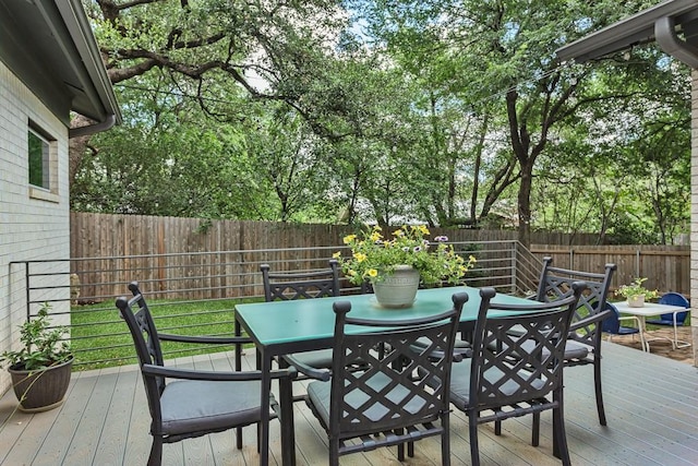 8702 Silverhill Ln, Austin, TX 78759 - wooden deck with outdoor dining area and a fenced backyard