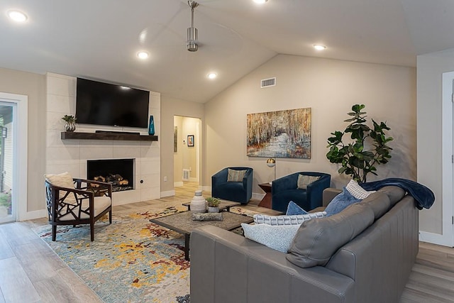 8702 Silverhill Ln, Austin, TX 78759 - living room featuring wood finished floors, ceiling fan, lofted ceiling, baseboards, and a fireplace