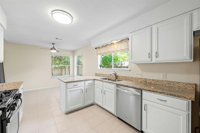 11921 Tanglebriar Trl, Austin, TX 78750 - kitchen featuring dishwasher, range with gas cooktop, a sink, a peninsula, and white cabinets