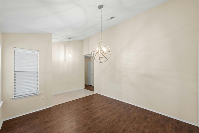 11921 Tanglebriar Trl, Austin, TX 78750 - unfurnished room with a chandelier, wood finished floors, and baseboards