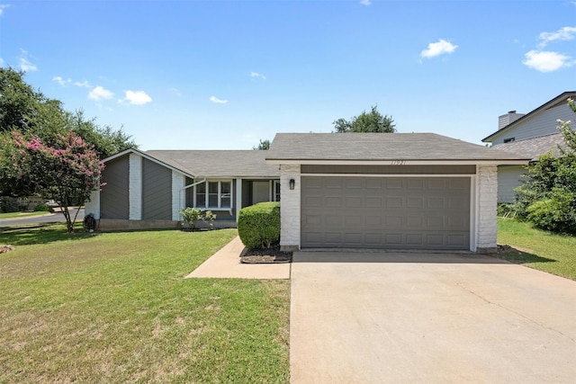 11921 Tanglebriar Trl, Austin, TX 78750 - view of front of property with a garage, driveway, and a front yard