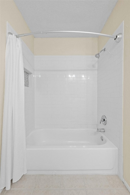 11921 Tanglebriar Trl, Austin, TX 78750 - bathroom with shower / bath combo with shower curtain, tile patterned flooring, and a textured ceiling