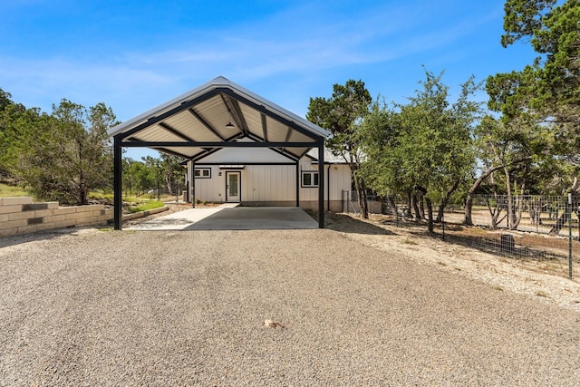 631 Lakeside Dr, Wimberley, TX 78676 - view of front of home with gravel driveway, a carport, and fence