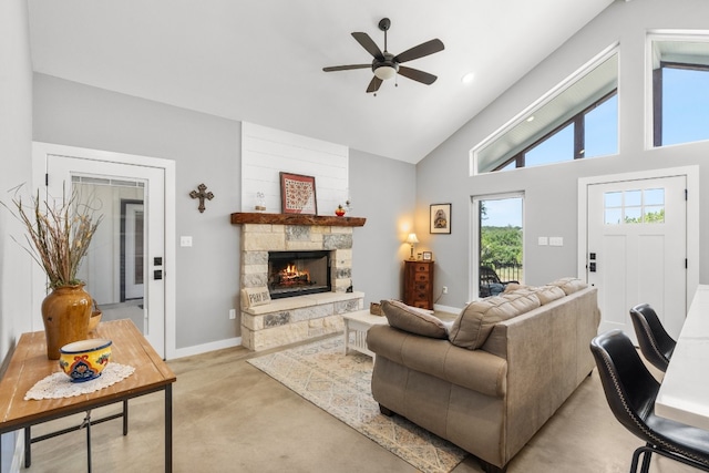 631 Lakeside Dr, Wimberley, TX 78676 - living area featuring light carpet, high vaulted ceiling, a stone fireplace, baseboards, and ceiling fan